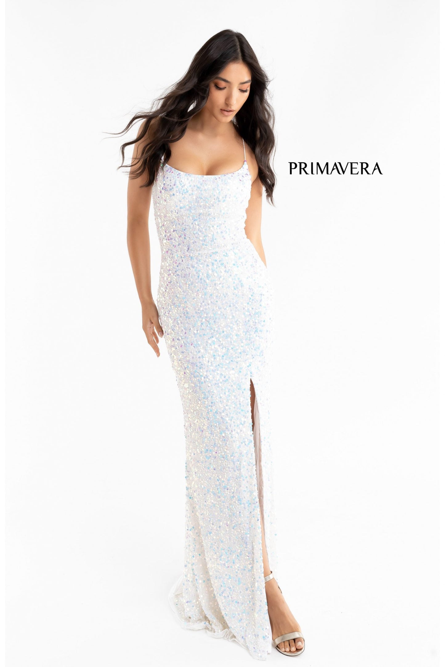 Primavera Couture 3290 This prom dress adds a pop to the multi sequins dress.  With a scoop neckline and spaghetti straps that cross and tie in the back.  This long evening dress has a side slit. 