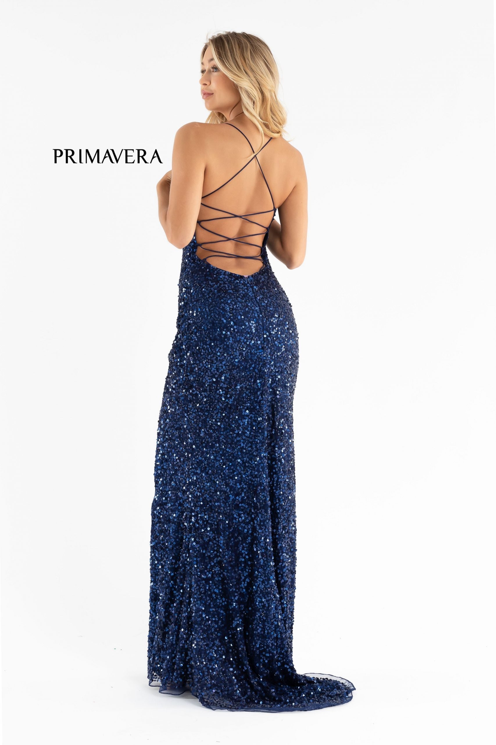 Primavera Couture 3290 This prom dress adds a pop to the multi sequins dress.  With a scoop neckline and spaghetti straps that cross and tie in the back.  This long evening dress has a side slit. 