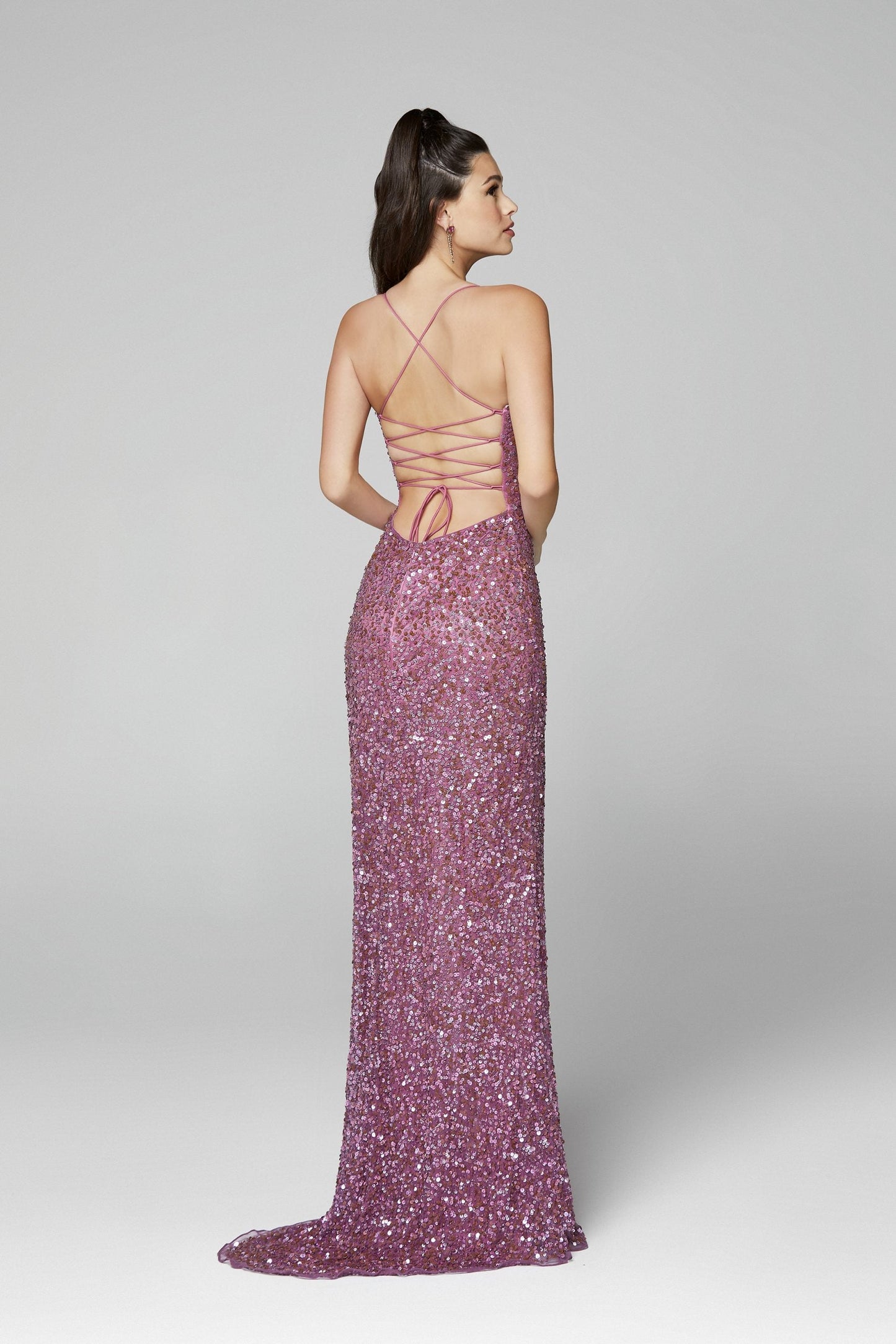 Primavera Couture 3290 This prom dress adds a pop to the multi sequins dress.  With a scoop neckline and spaghetti straps that cross and tie in the back.  This long evening dress has a side slit. 