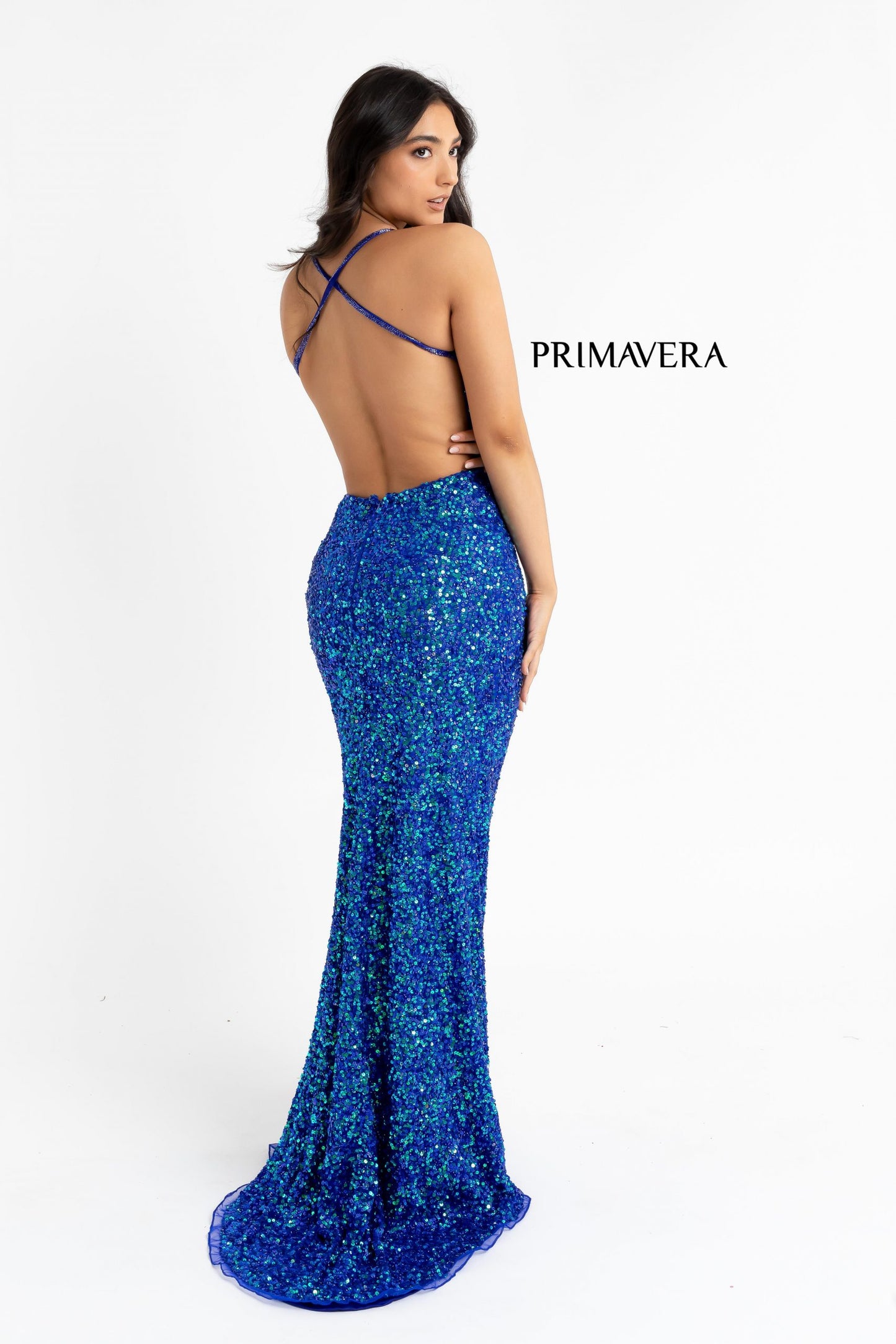 Primavera Couture 3291 Exclusive Prom Dresses.  This long prom dress is embellished throughout with shimmering sequins.  This impressive gown showcases a v neckline, thin beaded straps and crisscrossed straps in the open back. The long slim skirt has a sultry high side front slit. 