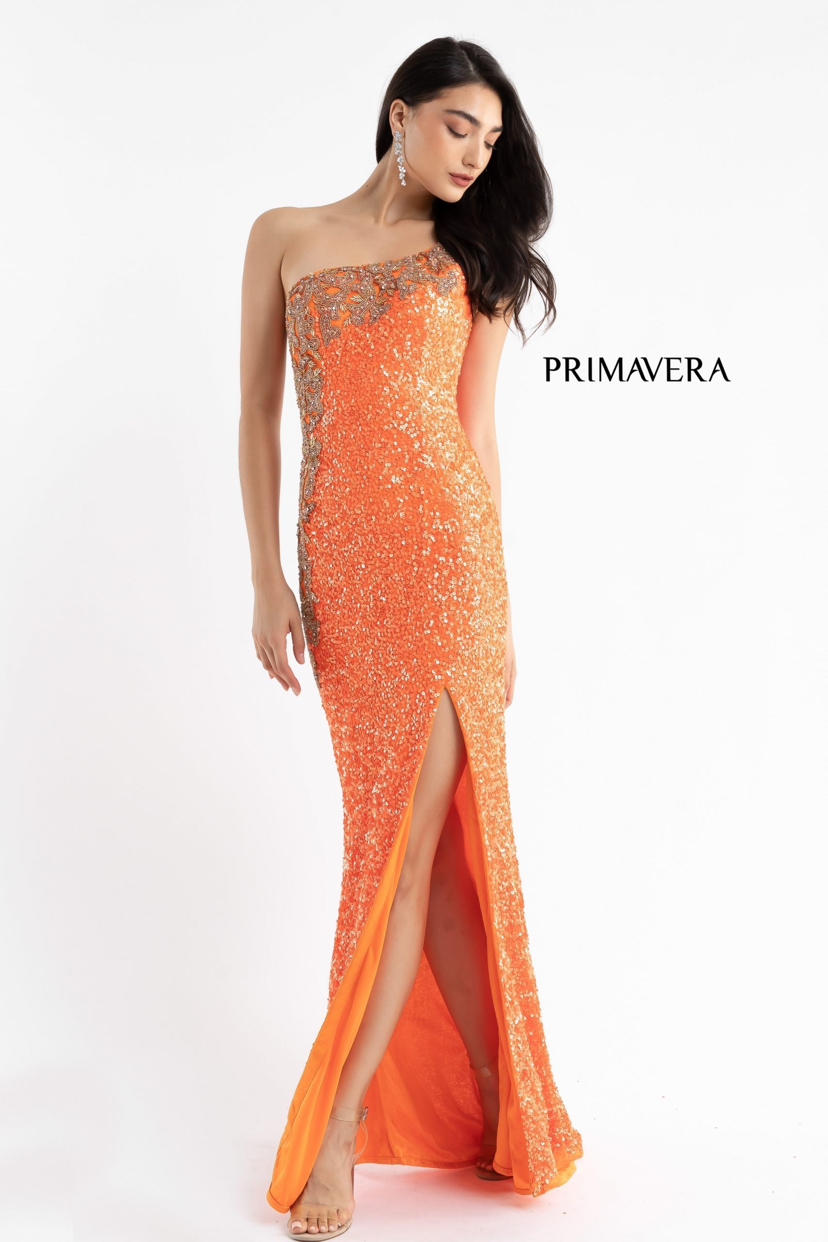 Primavera Couture 3637 is a stunning Long Fitted Sequin Embellished Formal Evening Gown. This One Shoulder Prom Dress Features Beaded Embellishments cascading from the one shoulder neckline down the side of the gown along the hip. Slit in skirt with a sweeping train. Great Pageant Formal Style.