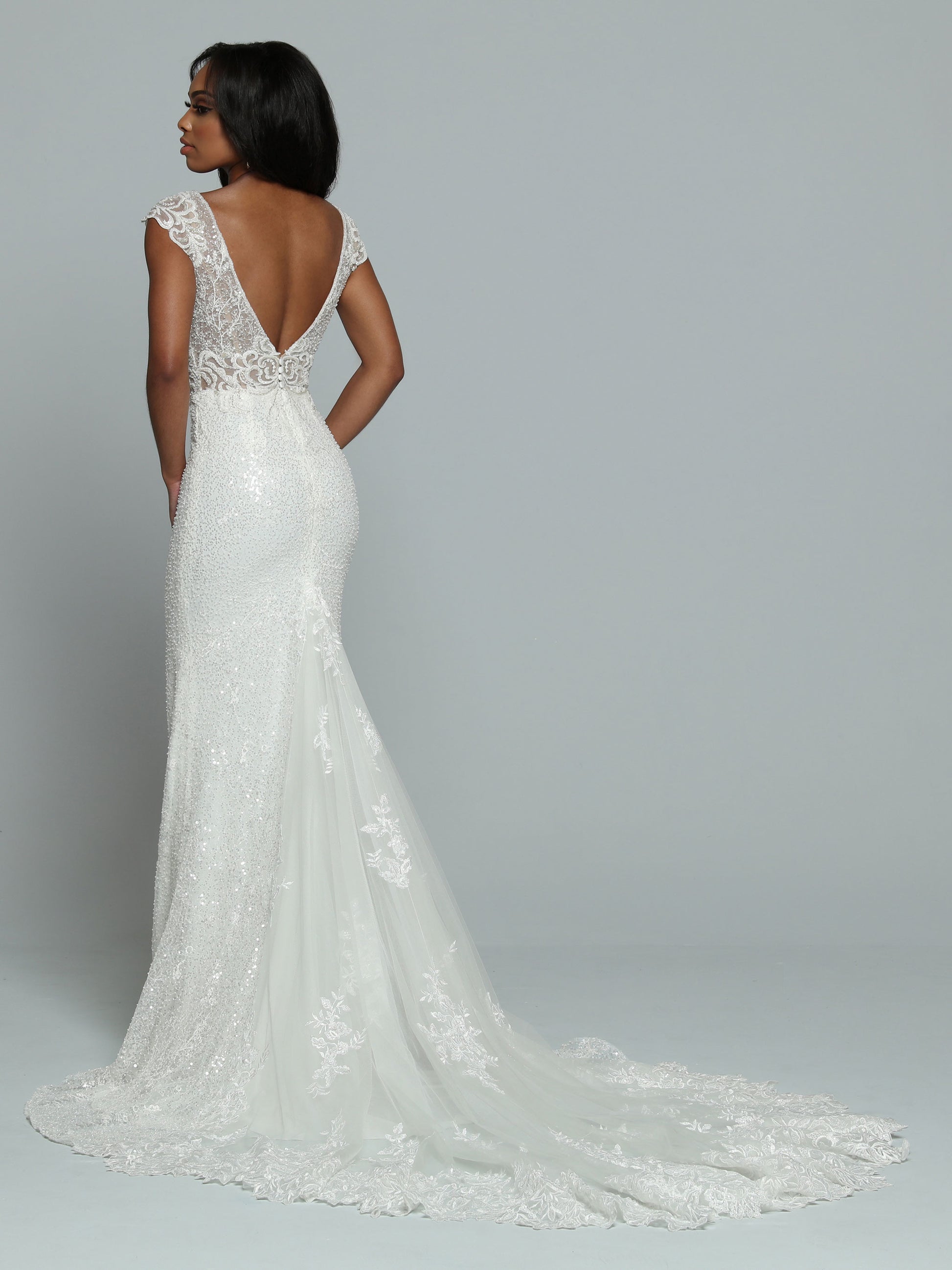 Davinci Bridal 50666 Long Sheer Sequin Mermaid Wedding Dress Lace Train Gown Sparkling Sequin Fit & Flare Sheath Wedding Dress features a Sheer Bodice with V-Neckline & Deep V-Back. Beaded Lace Applique covers the Bodice & Wide Off the Shoulder Straps. The Skirt has a Sheer Back Panel that ass Fullness to the Lace Edged Sheer Chapel Train.