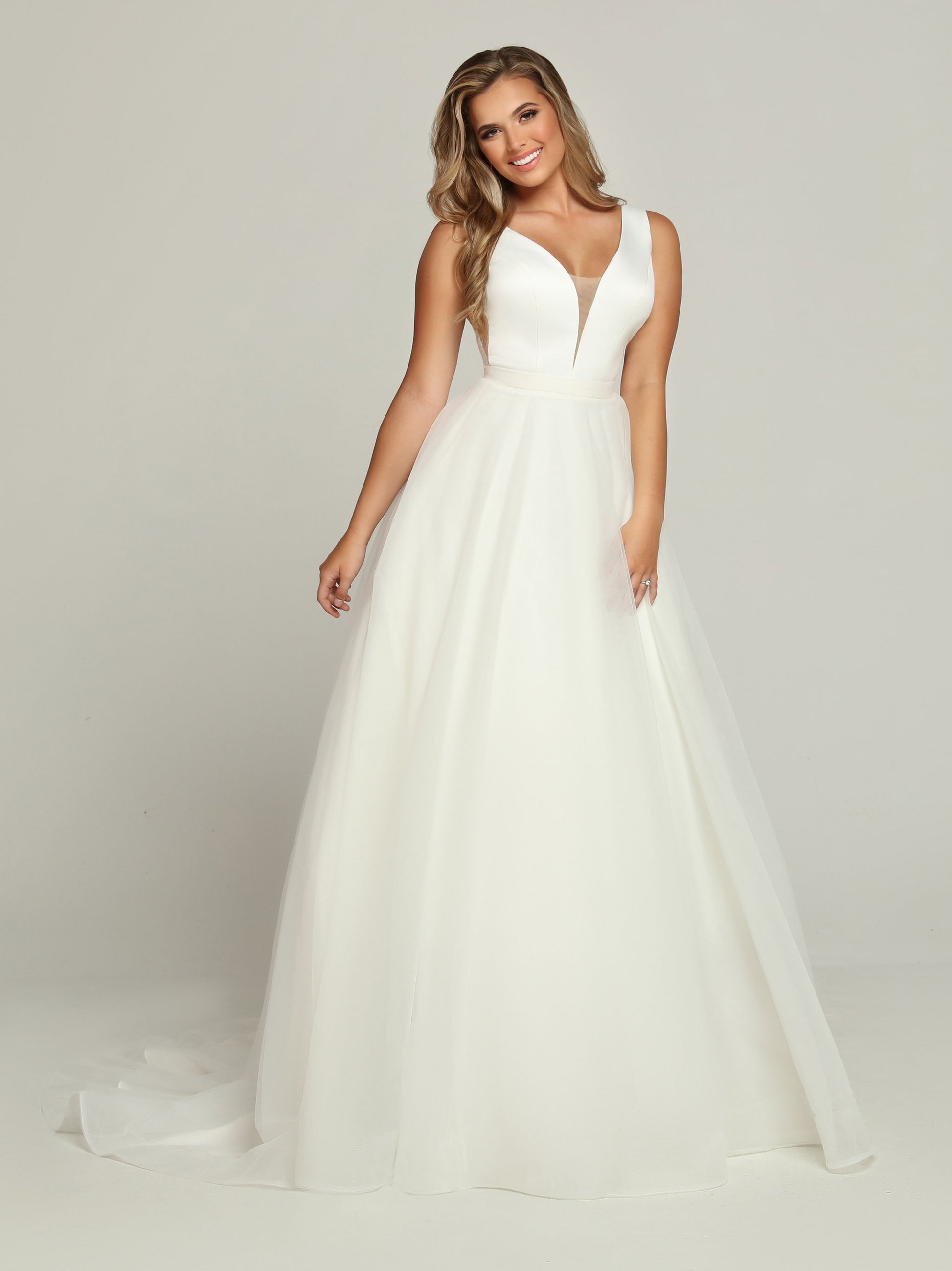 Davinci Bridal 50685 Tea length Ballgown removable skirt wedding dress Bridal Gown Tulle Two Looks in one, this Two-Piece Satin & Tulle A-Line Ball Gown Wedding Dress starts with a Plunging V-Neckline & Sheer Side Panels. The Scoop Back has a Sheer Overlay with a Covered Button Trim. Remove the Top Skirt with its Chapel Train to reveal a Pretty Tea Length Dress.