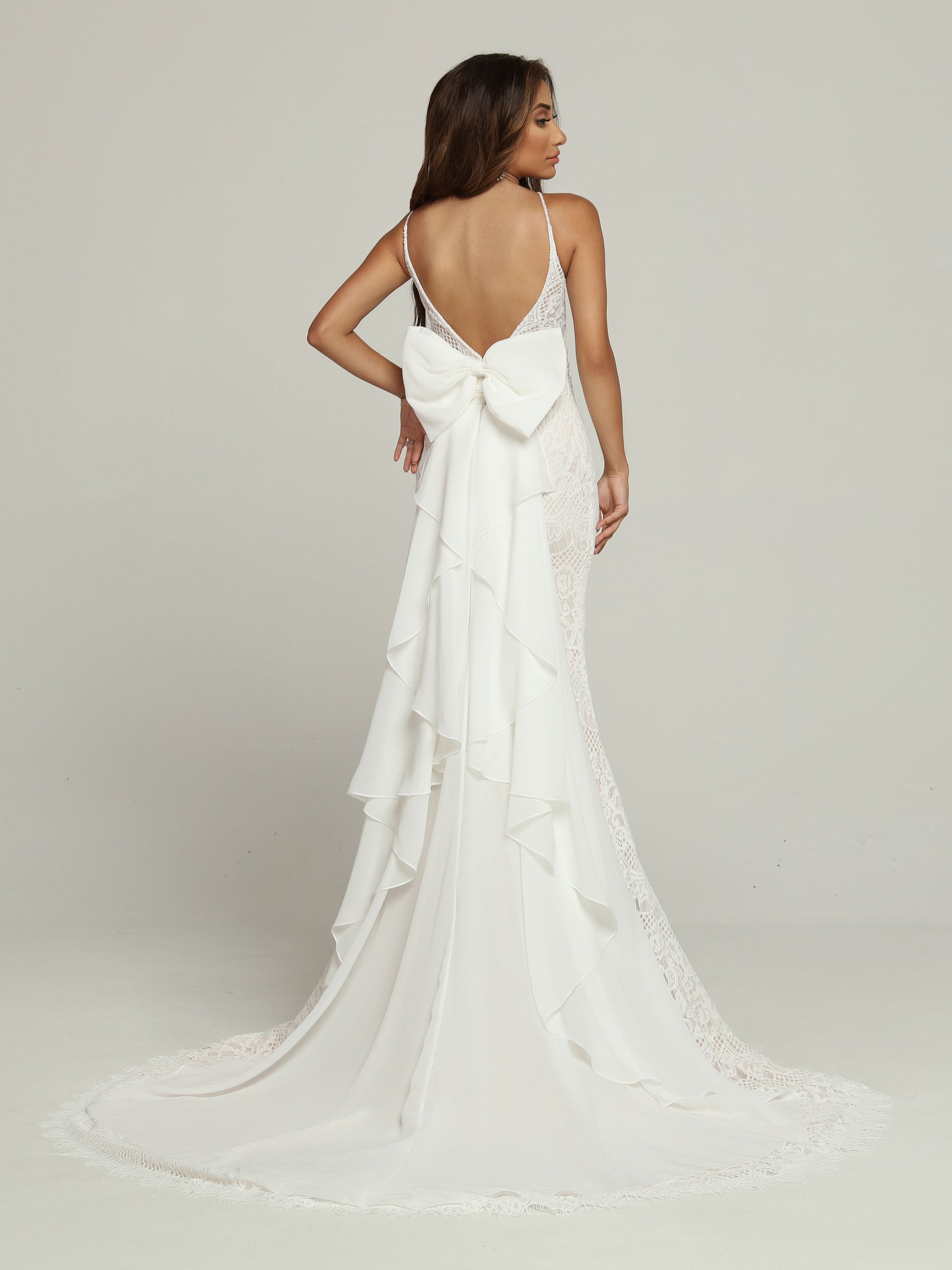 Davinci Bridal 50694 Boho Lace Romantic Mermaid Wedding Dress Bow Chiffon Bridal Gown Elegant with a Sweet Surprise, this Lace Fit & Flare Sheath Wedding Dress features a Plunging V-Neckline with Modesty Panel & a Low V-Back. A Wide Ruched Waistband sets off the Lace Skirt with its Chapel Train. The Surprise is the Oversized Back Bow & Ruffled Waterfall Style Chapel-Length Panel. oversize bow