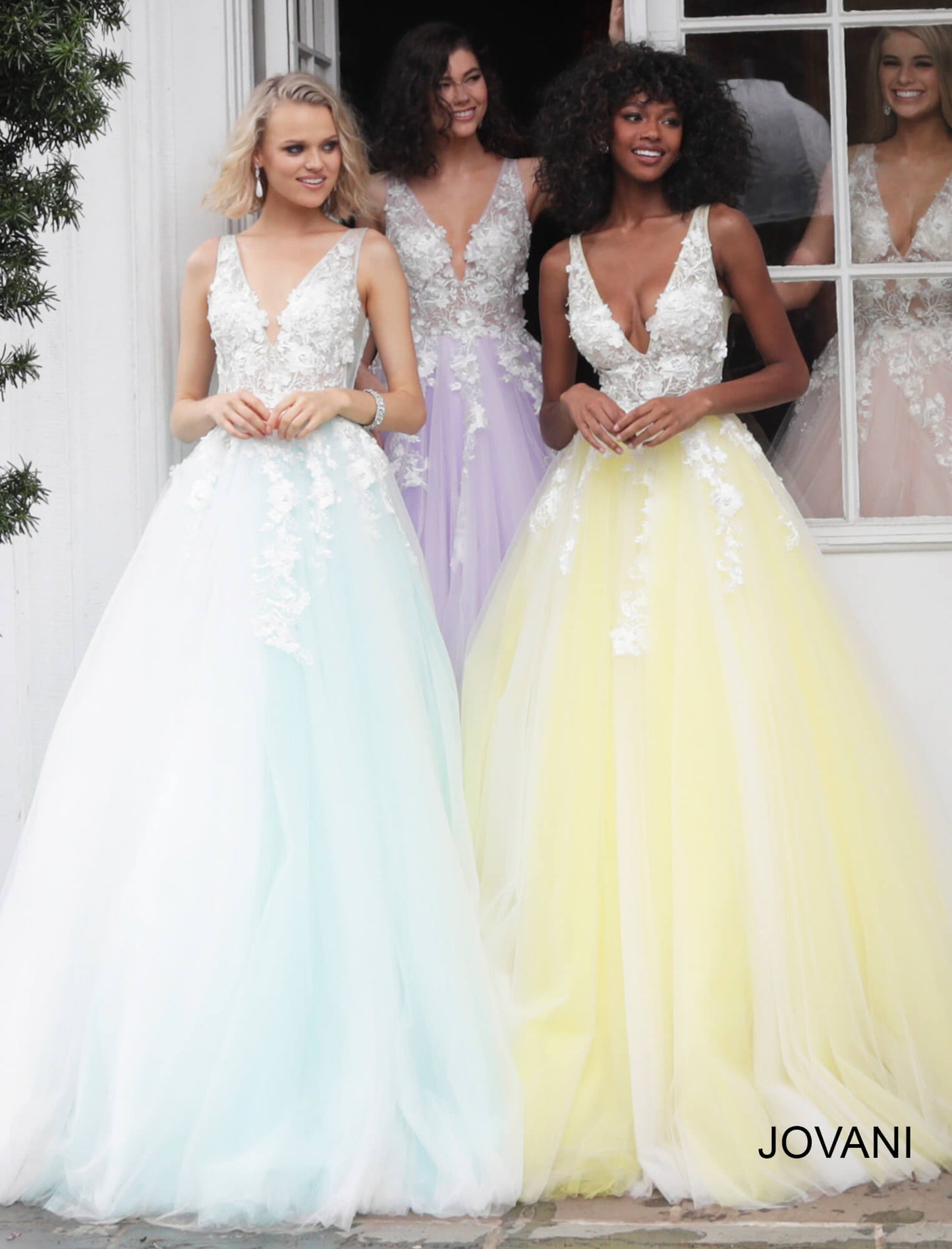 Jovani 55634 v neckline lace floral applique and tulle prom dress ball gown. Tulle ballgown, floor length, floral appliques, sheer sleeveless bodice, bra cups, v neckline and back. Available Colors: black/black, fuchsia, champagne, navy/black, off white/blush, off white/light blue, off white/off white, off white/yellow, off white/ lilac, red, teal  Available Sizes: 00 - 24