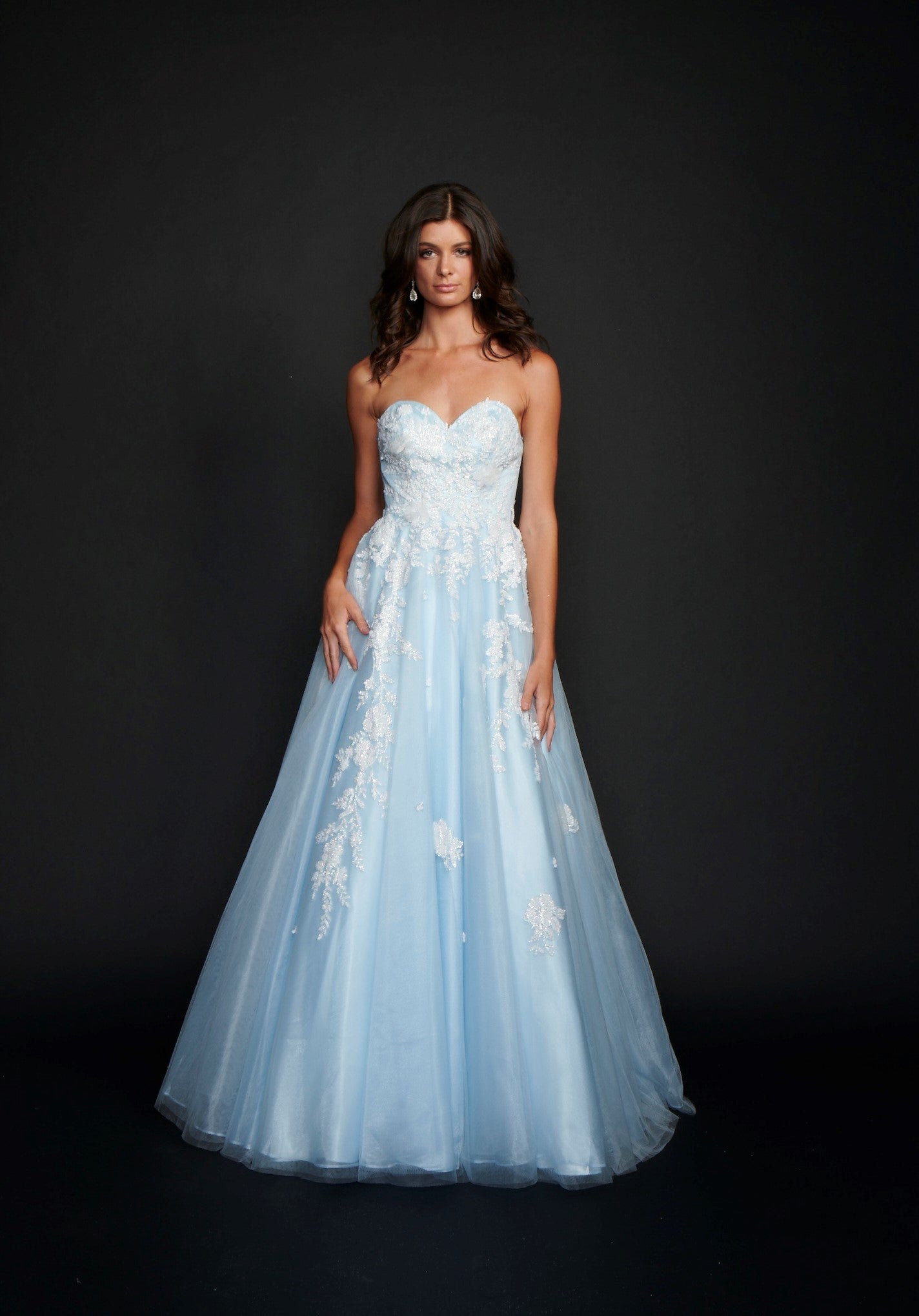 Nina Canacci 9137  This is a strapless ballgown with a sweetheart neckline and 3D floral appliques on the bodice and streaming down the dress. It is good for a Wedding dress or Prom Gown.   Available Size- 4-18  Available Color- Baby Blue, Ivory