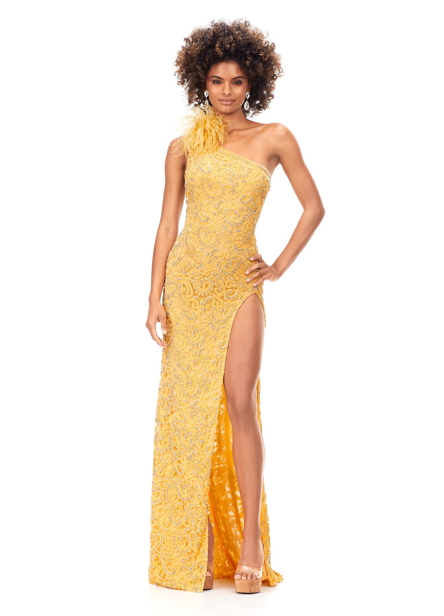 Ashley Lauren 11277 We are obsessing over this gown! This gorgeous one shoulder gown features crystals and beading throughout the bodice and carries onto the skirt. The one shoulder neckline is accented with feathers. The look is complete with a left leg slit and strappy open back. One Shoulder Intricate Sequin & Crystal Beading Left Leg Slit yellow