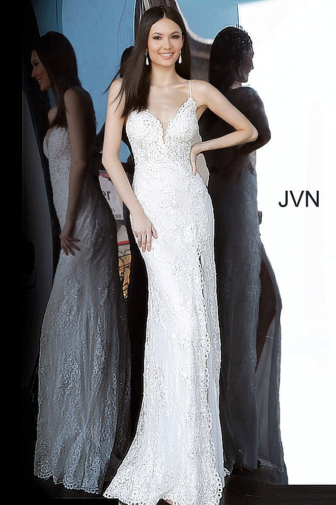 Jovani JVN00864 is an absolute stunner! Long Fitted Prom Dress or Unique Sexy Wedding Dress. Delicately Embellished Lace with a Plunging neckline & High Slit with scallop lace edges. Spaghetti straps with a slightly sheer lace bodice. JVN 00864