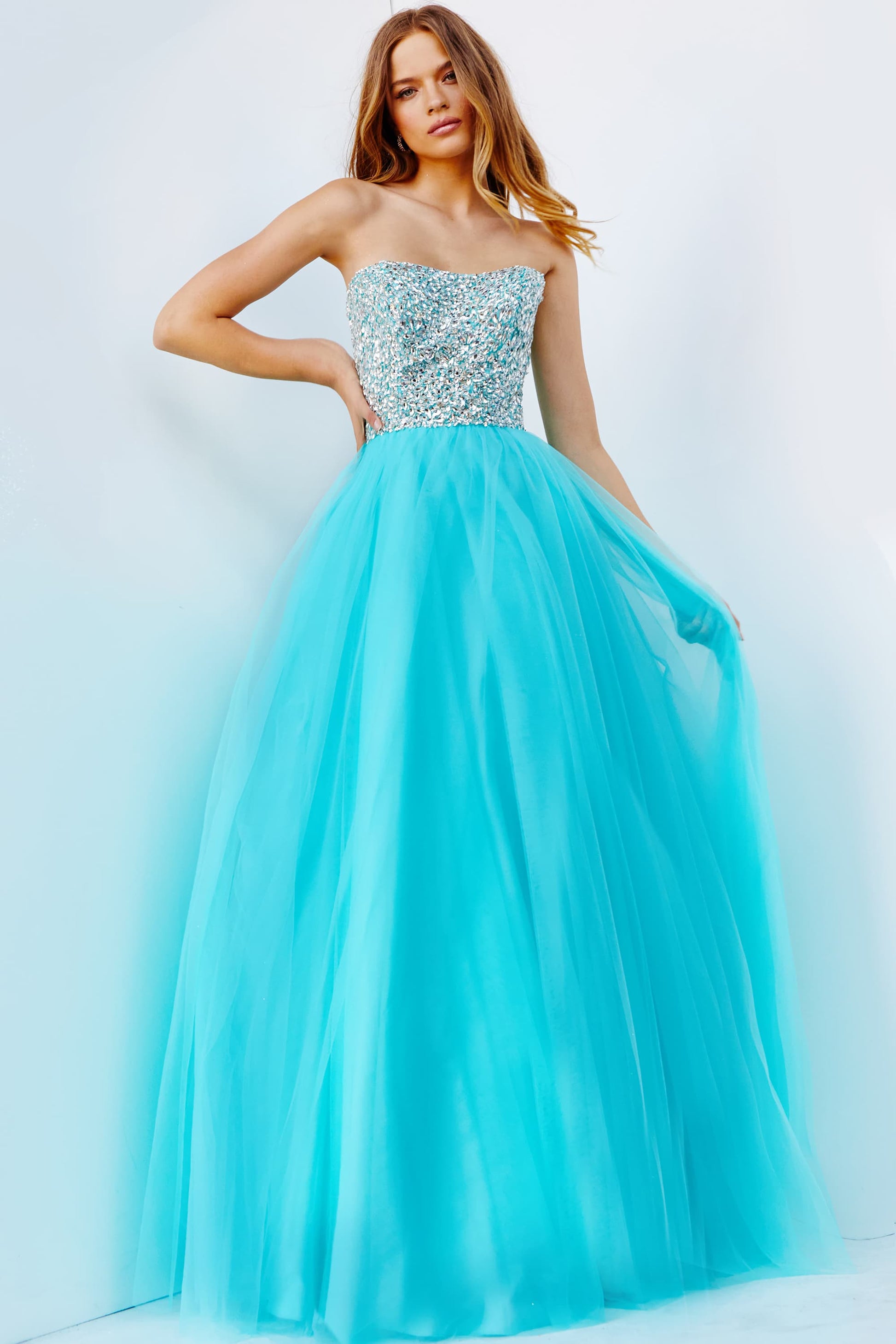 Jovani 52131 crystal embellished bodice strapless straight neckline tulle full long tulle skirt prom dress pageant gown evening dress JVN 52131 Exude elegance and grace with the Jovani 52131 Strapless Crystal Tulle A Line Pageant Dress. Featuring sparkling crystals and delicate tulle, this stunning gown is the perfect choice for any formal event. The A-line silhouette flatters all body types, while the strapless design adds a touch of glamour. Make a statement and shine like a star in this Jovani gown.