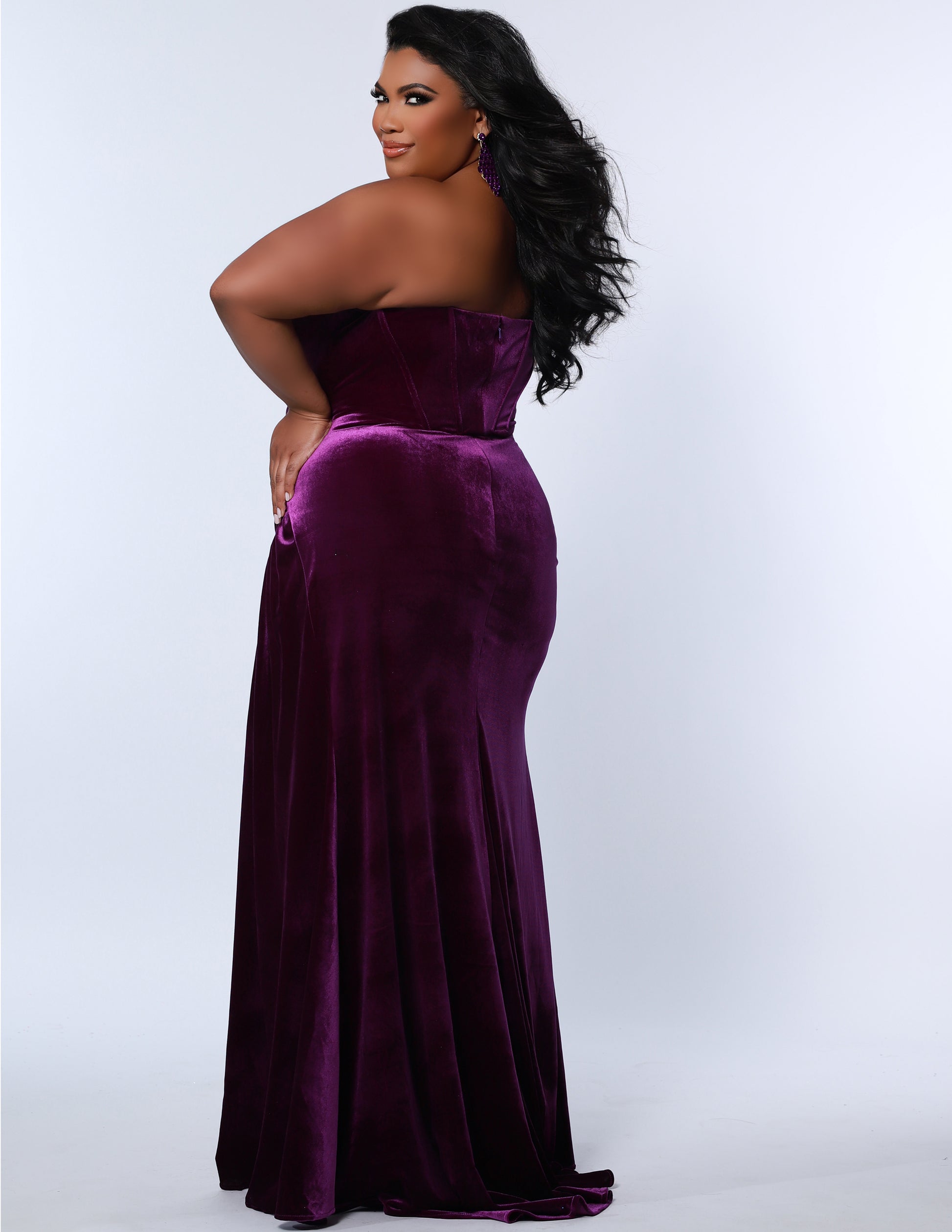 The Sydney's Closet SC7342 is a luxurious Velvet Prom Dress Strapless Evening Gown with a fitted and ruched silhouette, ideal for special occasions. It offers a classic and timeless look with a touch of sophistication. Its rich fabric provides a comfortable fit and feel.