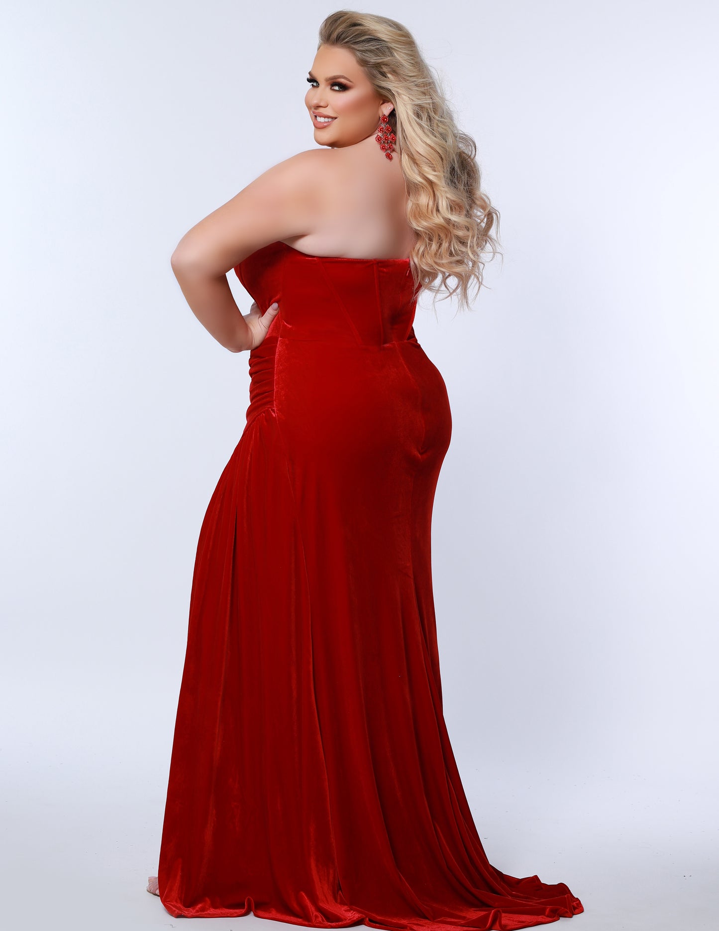 The Sydney's Closet SC7342 is a luxurious Velvet Prom Dress Strapless Evening Gown with a fitted and ruched silhouette, ideal for special occasions. It offers a classic and timeless look with a touch of sophistication. Its rich fabric provides a comfortable fit and feel.