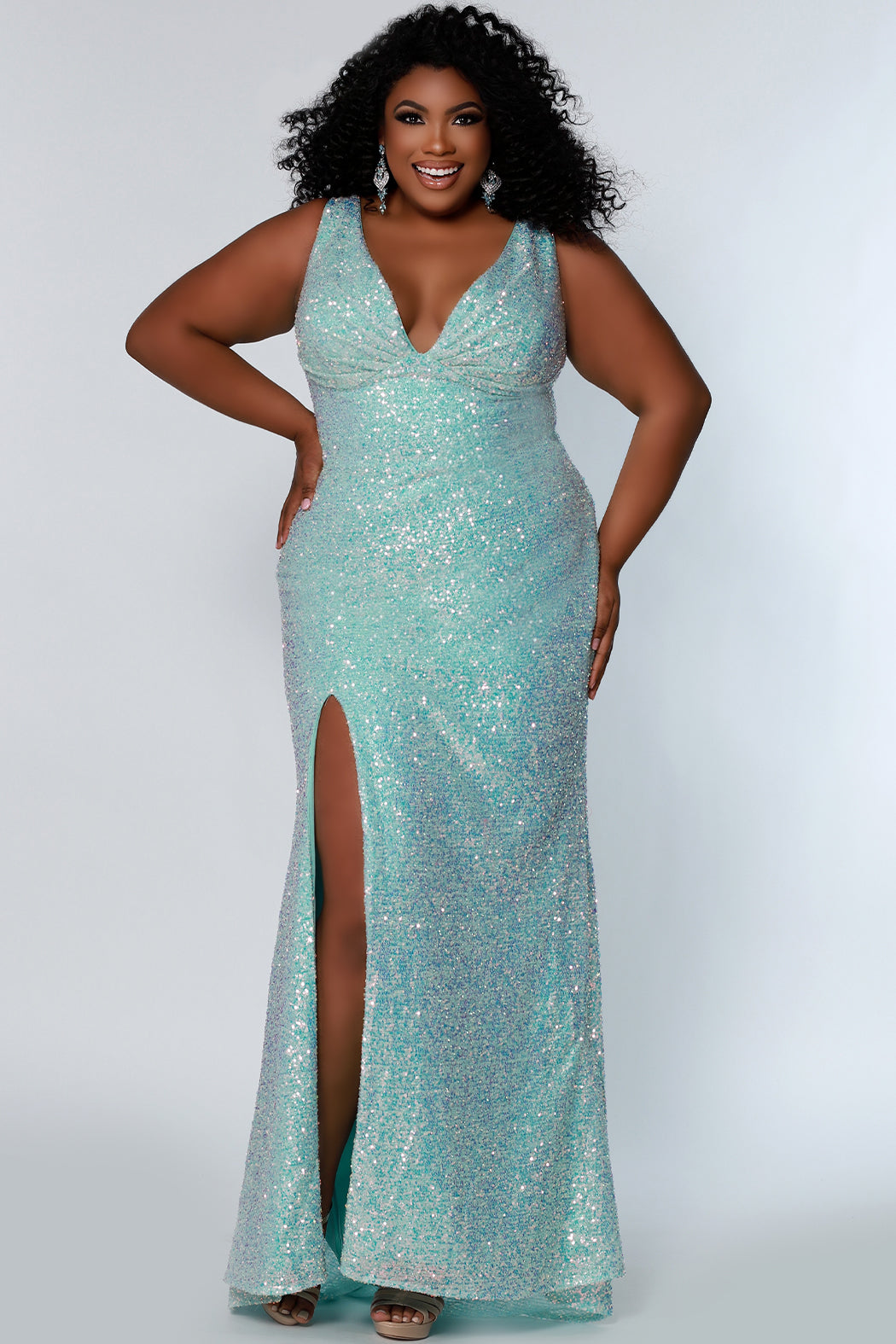 Tease Prom TE2201 Sydneys Closet Long Fitted Sequin Plus size prom dress slit  Colors: Aqua, Peach, Unicorn Size Availability: 14-28 Fitted silhouette V-neckline Pleated bodice Empire waistline Slit on right side of skirt 5 inch sweep train Bra-friendly straps Invisible zipper Scoop back Multi-dimensional sequins Stretch knit lining