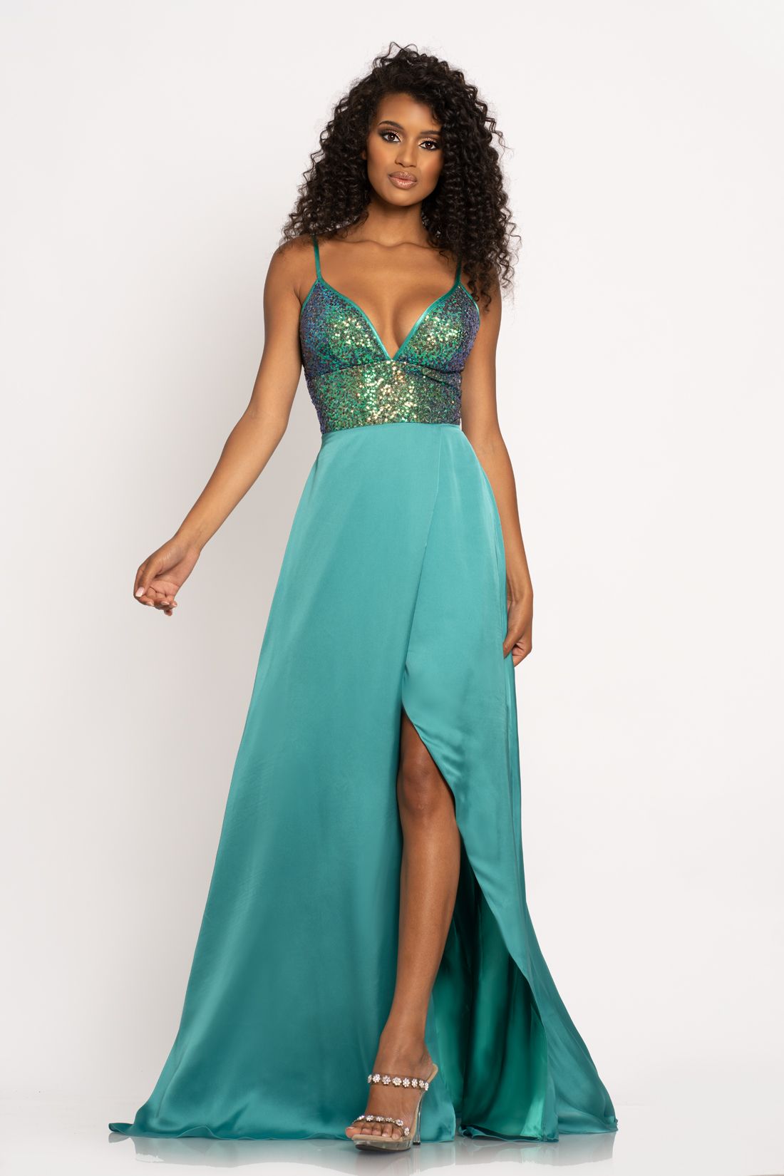 Johnathan Kayne 2214 Sequin bodice with a V neckline trimmed with charmeuse and spaghetti straps A line prom dress. The long charmeuse skirt on this pageant dress features a wrap style slit.   Colors Berry, Navy, Teal  Sizes  00, 0, 2, 4, 6, 8, 10, 12, 14, 16 