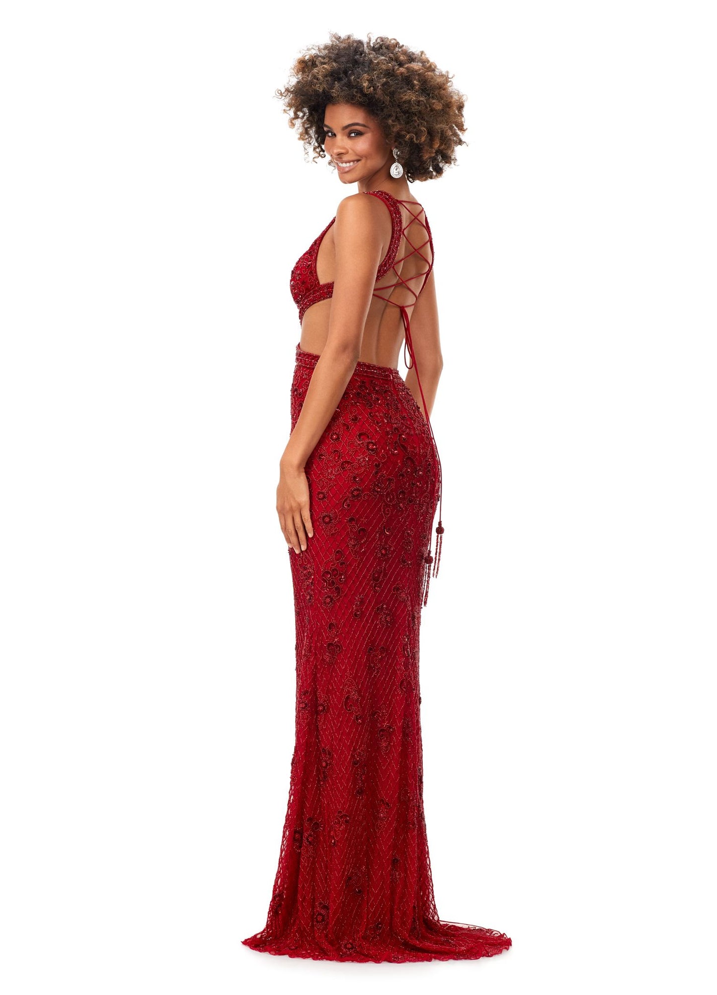 Ashley Lauren 11366 Turn heads in this v-neck gown with side cut outs and an intricate bead pattern. The gown is complete with a lace up open back and sweep train. V-Neckline Cut Outs Lace Up Back Sweep Train COLORS: Gold, Red, Lilac, Peacock