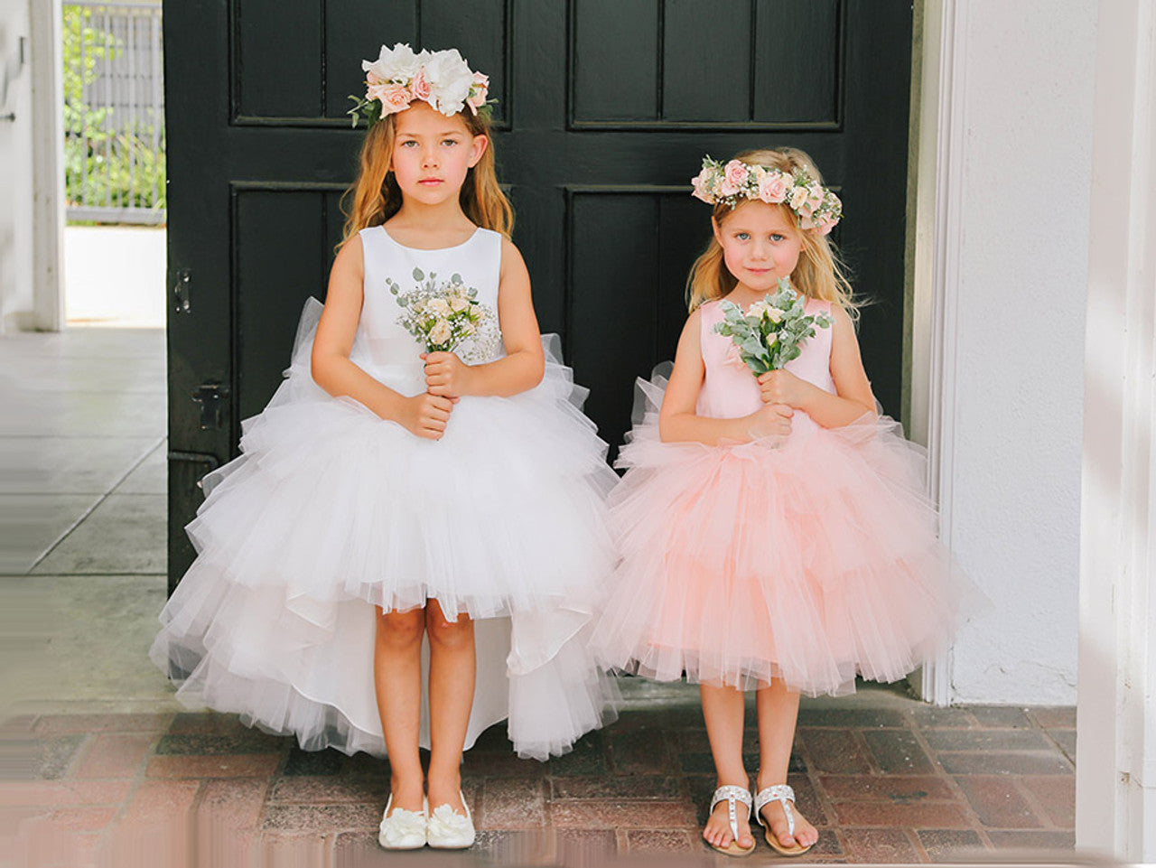 This Tip Top 5658 Girls Layered Tulle High Low Skirt Formal Dress is a perfect choice for that special day. The tulle high-low skirt, satin formal gown, and flower girl satin sash come together to create a beautiful, unique look perfect for flower girls, junior bridesmaids or formal occasions.  Sizes: 6M-16  Colors: Black, Blush, Burgundy, Eggplant, Ivory, Red, Royal Blue, White, Champagne, Lilac, Sky Blue